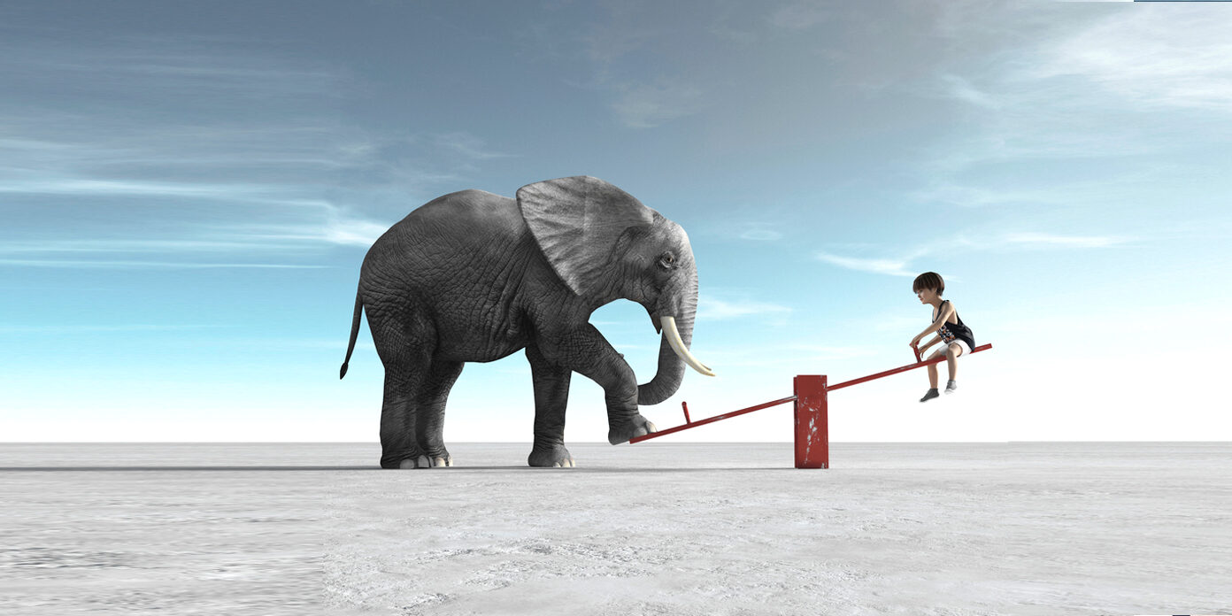 The man climbs on a ladder supported by a big bulb.